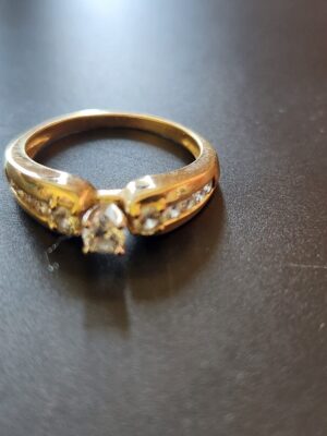 0.18 CT H/I I1 Round Cut Diamond with Two 0.18 TW H/I I1 Side Diamonds Yellow Gold Ring