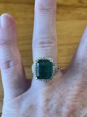 6.39 CT Step Cut Emerald Surrounded by Round Brilliant Diamonds 14 KT Gold Ring